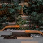 brown wooden bench near green plants as part of a minimalist designed garden one of the top landscaping trends of 2025
