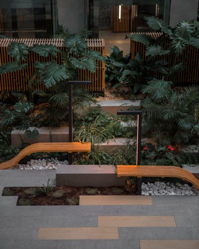 brown wooden bench near green plants as part of a minimalist designed garden one of the top landscaping trends of 2025