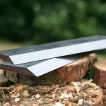 Equipment Maintenance with sharpened blades on a wood pile