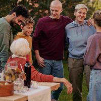 Family enjoying a relaxed Mother’s Day appreciation moment together outdoors with simple shared time