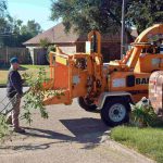 On-site wood chipping of large branches and logs into reusable mulch